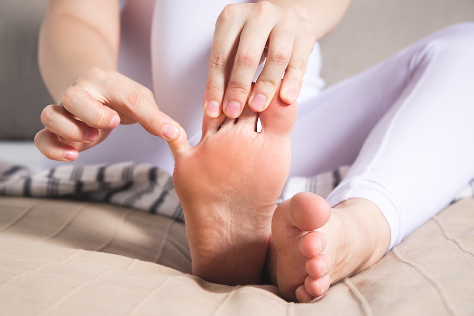 Woman's leg hurts, pain in the foot, massage of female feet
