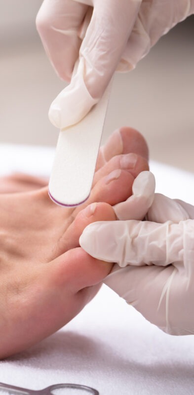 Man Undergoing Pedicure Process In Salon